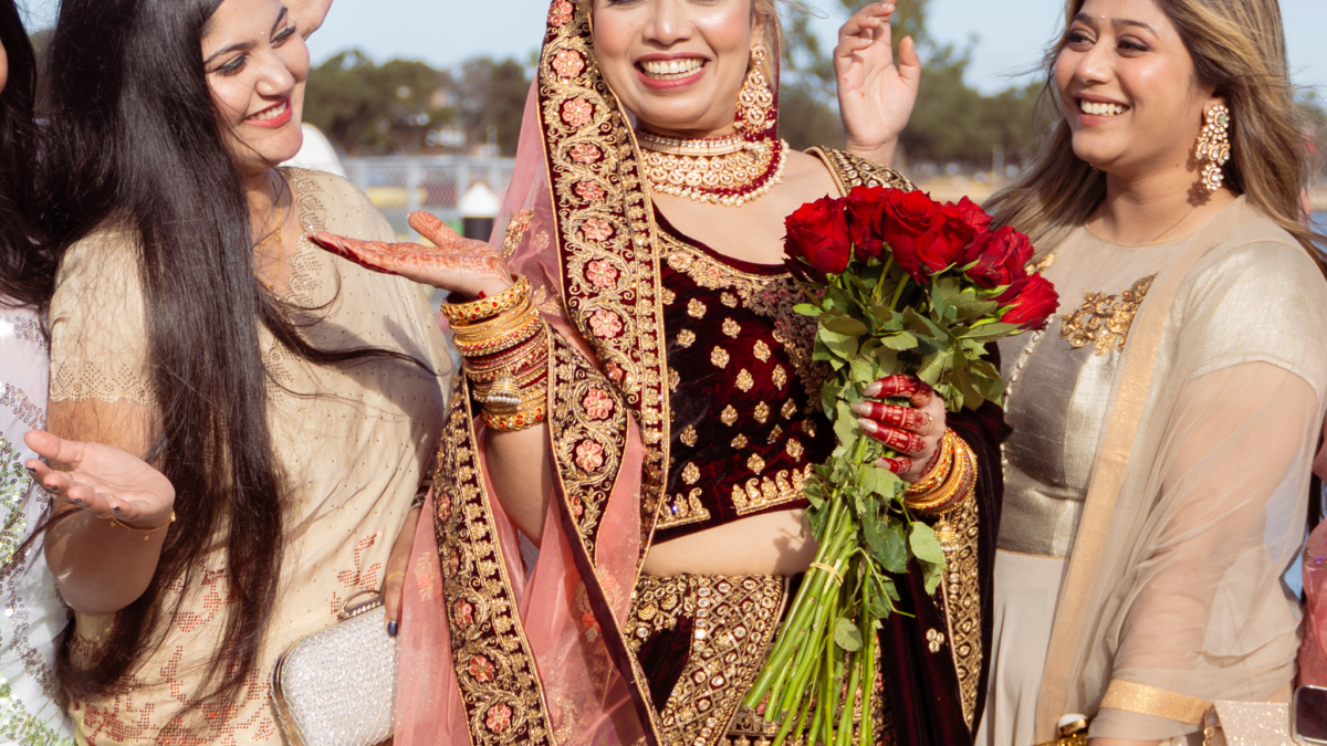 Bride in traditional attire with friends celebrating in Mandurah, Perth WA.