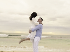 Romantic kiss on the shore with waves splashing at Trigg Beach, WA.